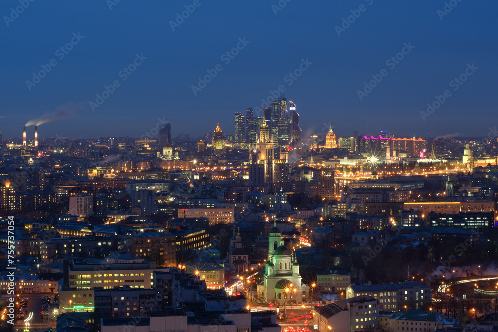 Panoramic view of Moscow City business complex, Stalin skyscrapers, residential buildings and churches at night in Moscow, Russia