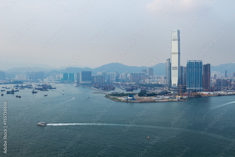 Skyscraper One Island East Centre and sea shore in business area in mist in Hong Kong, China, view from China Merchants Tower