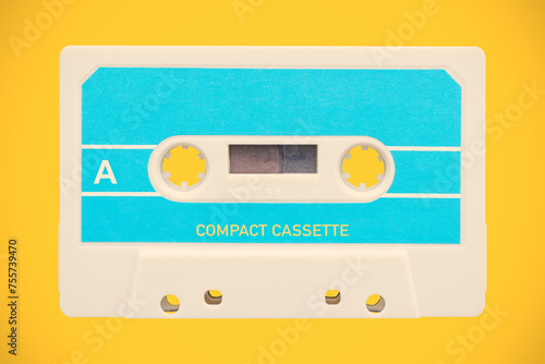 Vintage blue with white audio compact cassette in front of an orange background