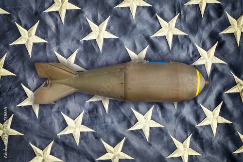 Ancient military missile bomb in front of the stars of an American flag