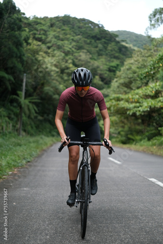 A young woman cyclist riding her gravel bike in the mountains. © Jonathan De Guzman