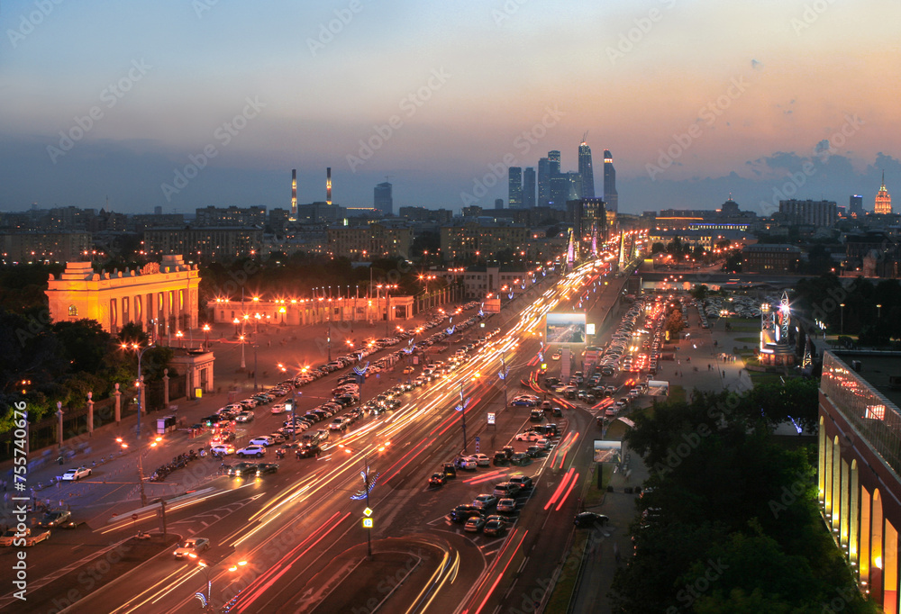 Krymsky Val Street, traffic, entrance arch in Gorky Park in Moscow night, Russia