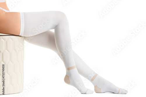 Legs in white compression stockings on a white background, thromboembolism, varicose veins.