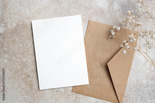 Wedding invitation card mockup with dry gypsophila flowers and envelope, copy space for card design presentation