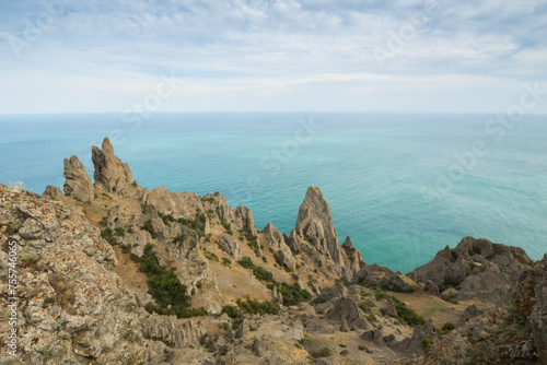 Rocks near sea waterside, skyline and blue water at summer day