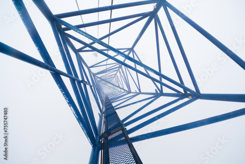 Inside top of crane on skyscraper under construction in clouds photo