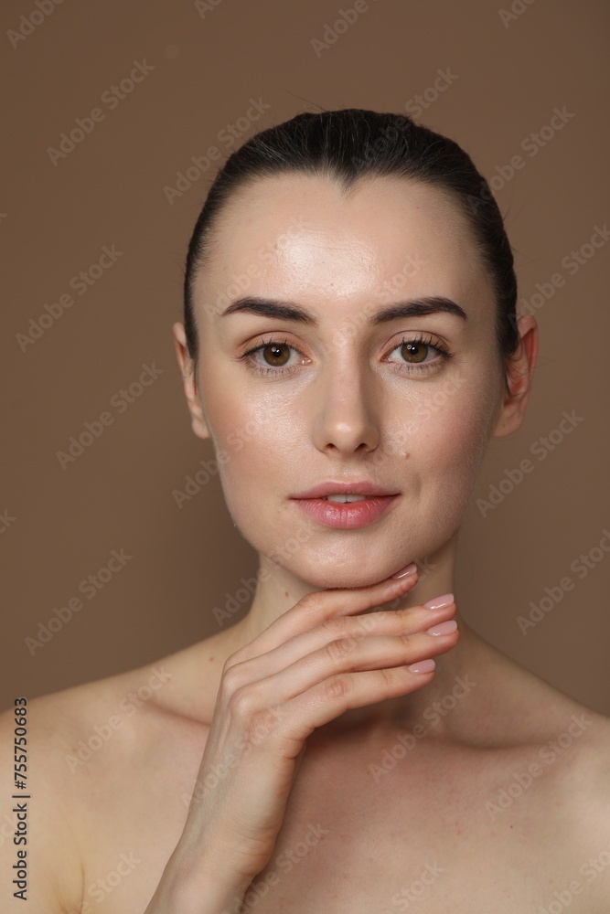 Portrait of beautiful young woman on light brown background Portrait of beautiful young woman on light brown background