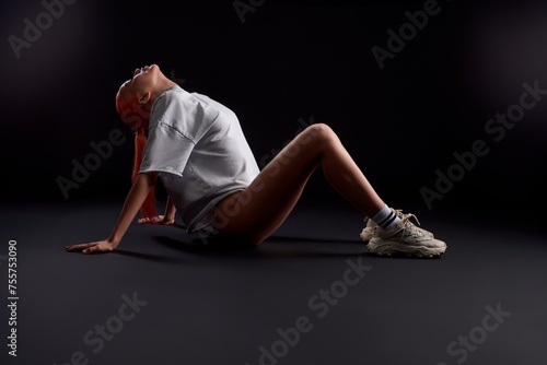 Graceful woman in casual shirt laying on the floor with her head up