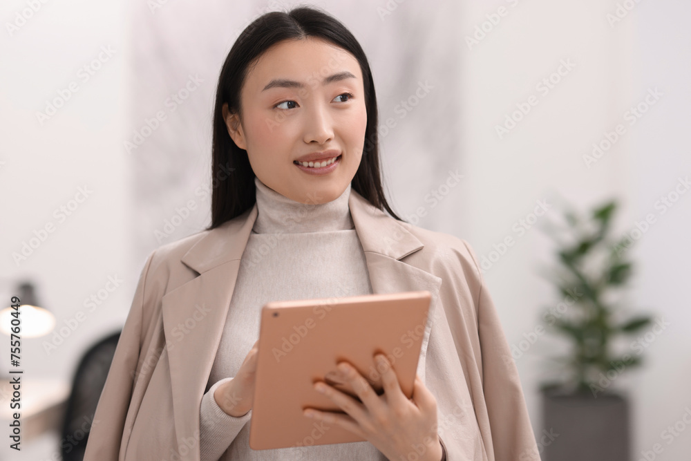 Portrait of smiling businesswoman with tablet in office Portrait of smiling businesswoman with tablet in office