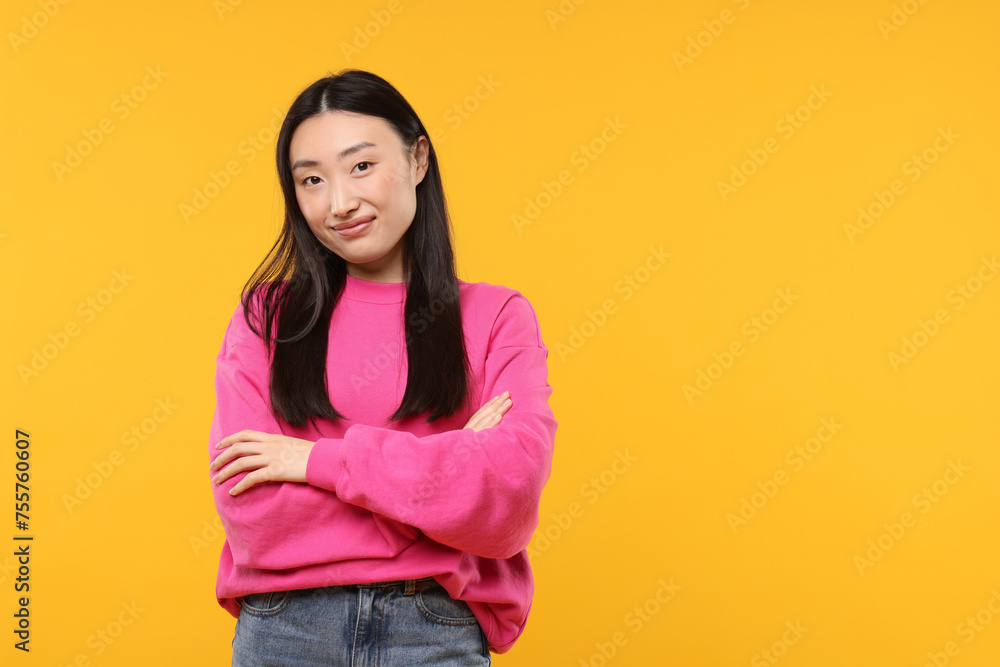 Portrait of beautiful woman on orange background. Space for text Portrait of beautiful woman on orange background. Space for text