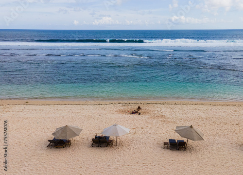 Wallpaper Mural Aerial view of sandy beach and umbrella in Melasti Beach, a tropical beach, famous tourist destination located in Bali Island, Indonesia. Torontodigital.ca