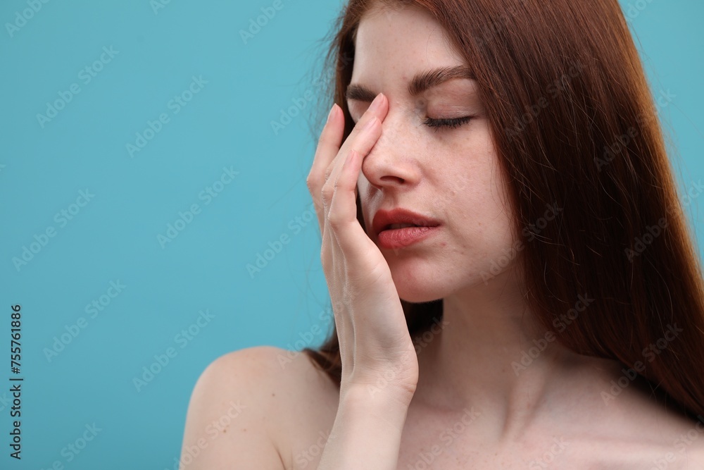 Portrait of beautiful woman with freckles on light blue background, closeup. Space for text Portrait of beautiful woman with freckles on light blue background, closeup. Space for text
