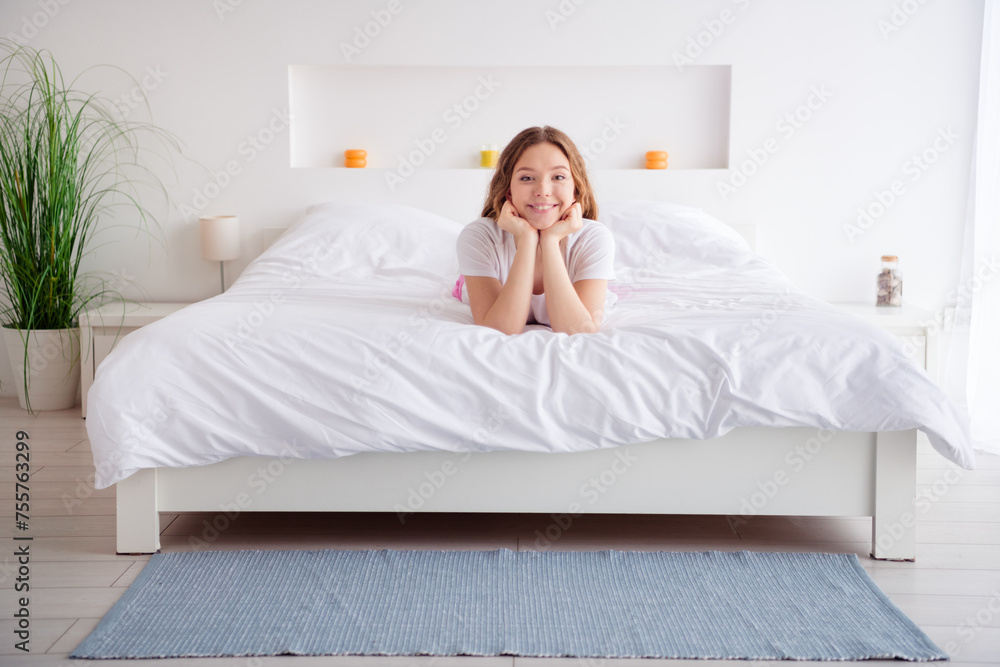 Full length portrait of cheerful carefree girl have good mood laying comfy bed spend pastime modern bedroom house inside Full length portrait of cheerful carefree girl have good mood laying comfy bed spend pastime modern bedroom house inside