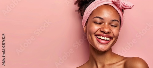 Young afro american woman with pink headband and clean fresh skin on beige pink pastel background