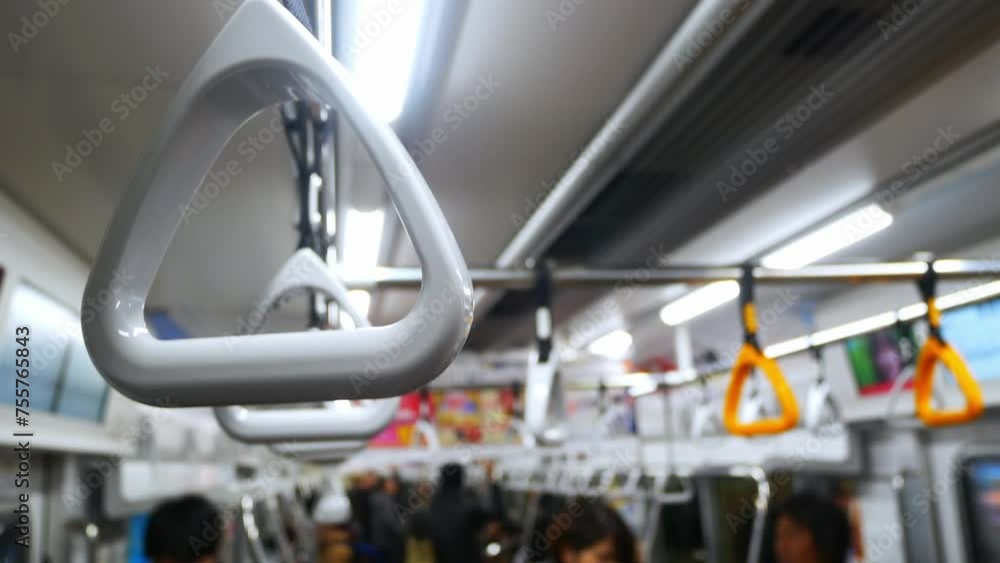Close up view with selective focus of a looped handle handrails hold in subway train commuter urban public transportation Close up view with selective focus of a looped handle handrails hold in subway train commuter urban public transportation
