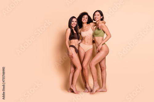 Studio full length no retouch photo of stunning pretty ladies hugging accepting themselves empty space isolated pastel color background