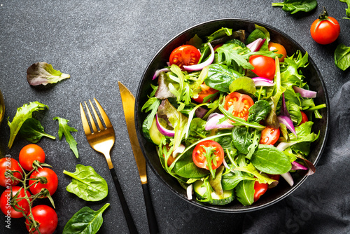 Healthy food, vegan bowl. Green Salad with fresh leaves and vegetables. Flat lay with copy space.