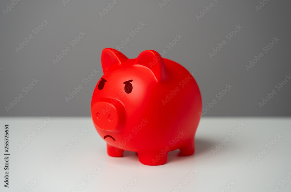 Angry red inflated piggy bank. Inflation is burning savings. Overheated financial market. Difficult economic conditions. Heavy burden on the budget, high expenses and the likelihood of bankruptcy. Angry red inflated piggy bank. Inflation is burning savings. Overheated financial market. Difficult economic conditions. Heavy burden on the budget, high expenses and the likelihood of bankruptcy.