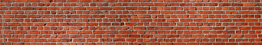 Panoramic banner of red bricks. Facade of a historic building in Iserlohn Sauerland Germany. Uniform grid made by macons in the 19th century. Colorful architecture background in red, brown and orange. Panoramic banner of red bricks. Facade of a historic building in Iserlohn Sauerland Germany. Uniform grid made by macons in the 19th century. Colorful architecture background in red, brown and orange.