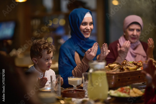 In a modern restaurant setting, a European Islamic family comes together for iftar during Ramadan, engaging in prayer before the meal, uniting tradition and contemporary practices in a celebration of