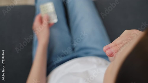 Selective focus of young woman opening birth control pills, holding hormonal oral contraceptive medicine, take pharmaceutical to prevention, safe virus sex disease. Contraception and pregnancy concept photo