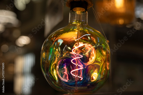 Colored lamp. Spiral in glass. Glass incandescent lamp.