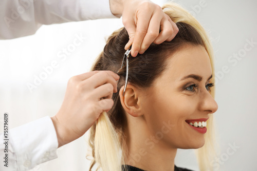 Hair styling. Professional hairdresser working with smiling client indoors, closeup