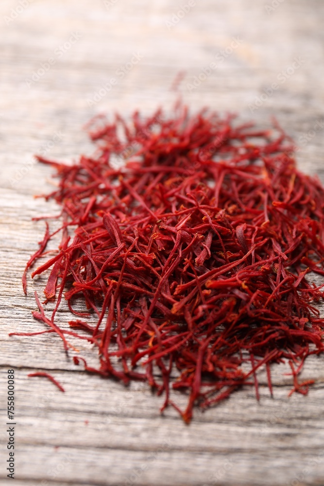 Fototapeta premium Aromatic saffron on wooden table, closeup view