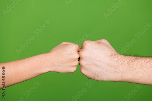 Photo of two people hands palms touching fists showing conflict situation isolated green color background