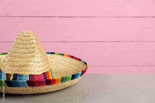 Mexican sombrero hat on grey table, closeup. Space for text