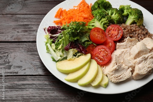 Balanced diet and healthy foods. Plate with different delicious products isolated on wooden table