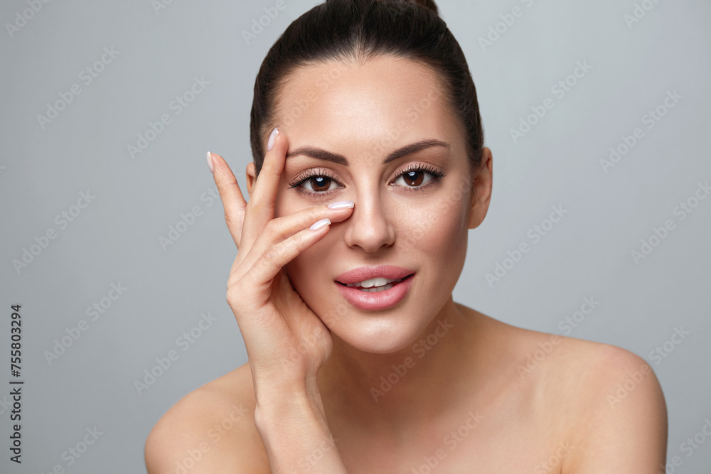 Beautiful Young Woman With Clean Perfect Skin. Portrait Of Beauty Model With Natural Nude Make Up And Touching Her Face. Spa, Skincare Beautiful Young Woman With Clean Perfect Skin. Portrait Of Beauty Model With Natural Nude Make Up And Touching Her Face. Spa, Skincare