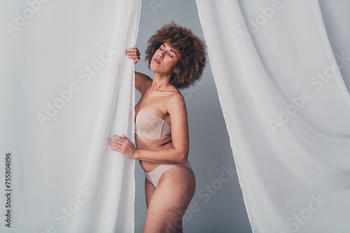 Unretouched photo of stunning girl touch soft veil curtain enjoy softness advertising isolated grey color background