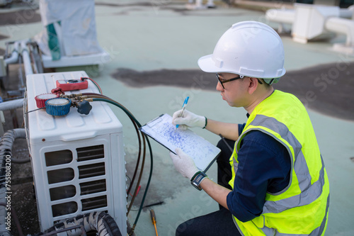 Refrigeration and Air Conditioning Engineering Detects Plant Cooling Problems,electrician maintenance Condensing on the rooftop outdoors of large industrial building,engineer under checking the indust