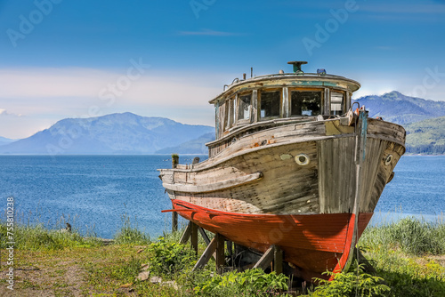 A rotting abandoned old wooden fishing boat in Icy Strait Point, Alaska photo