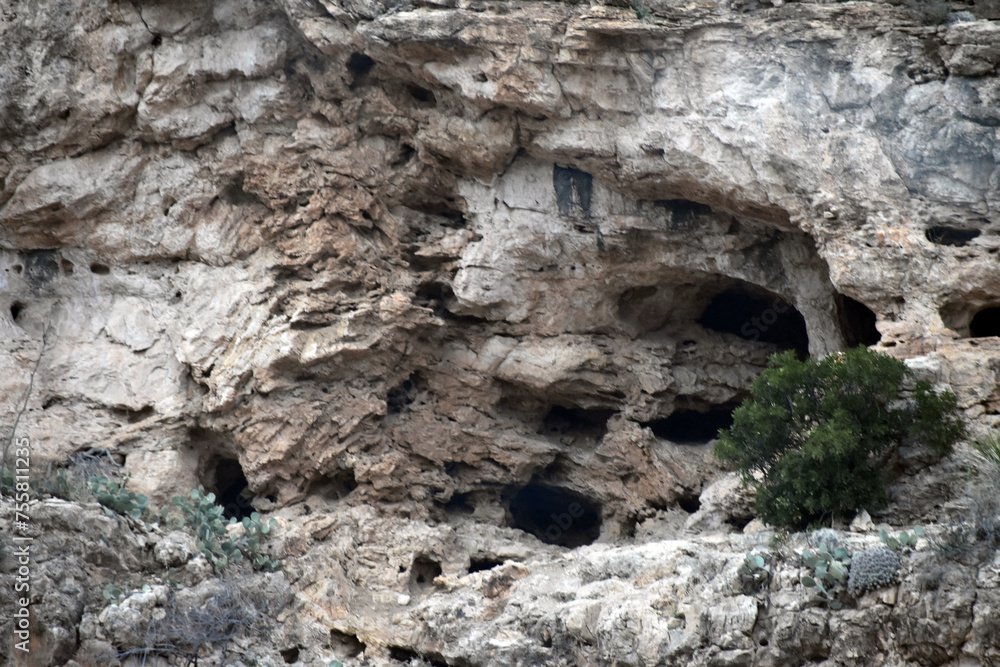 Cave Openings in a Rock Face New Mexico Cave Openings in a Rock Face New Mexico