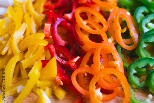Vibrant Sliced Bell Peppers on Wooden Surface - Ideal for Healthy Eating and Cooking Concepts