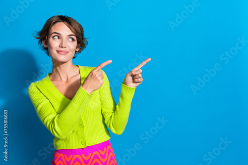 Portrait of gorgeous lady look indicate fingers empty space proposition news isolated on blue color background
