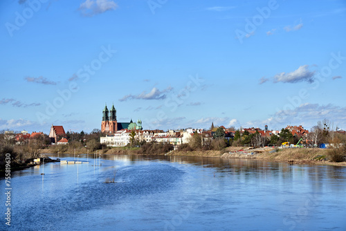 Historic buildings and towers of the gothic cathedral on the Warta River. in the city of Poznan