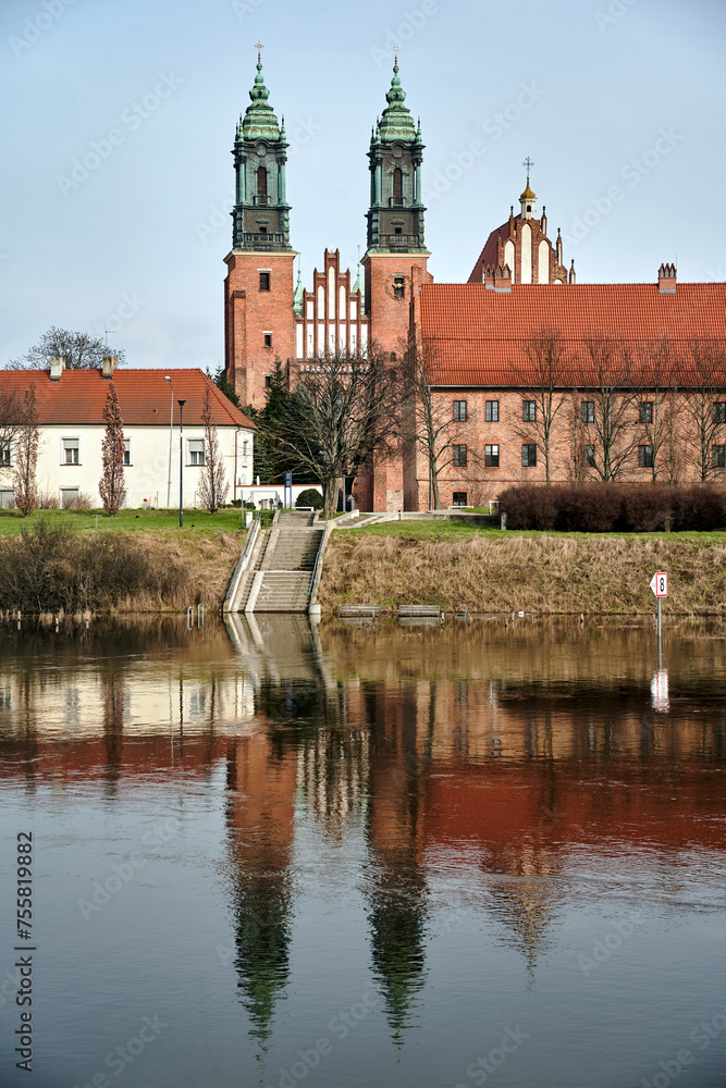 Historic buildings and towers of the gothic cathedral on the Warta River in the city of Poznan,