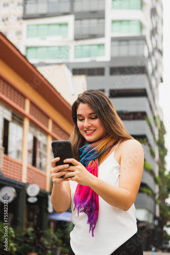 vertical shot of woman texting on cell phone