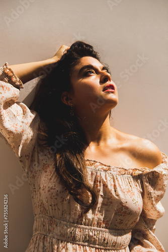 Woman touching her hair looking up