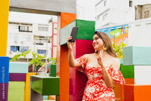 Young woman taking a portrait in colorful environment