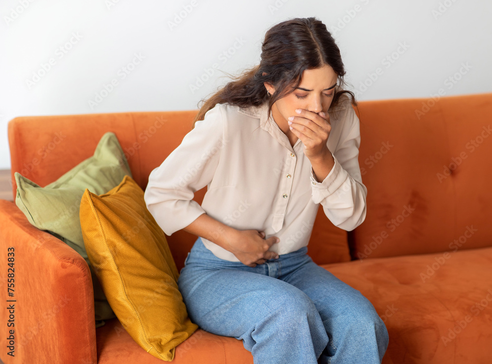 Portrait Of Young Woman Suffering From Nausea At Home Portrait Of Young Woman Suffering From Nausea At Home