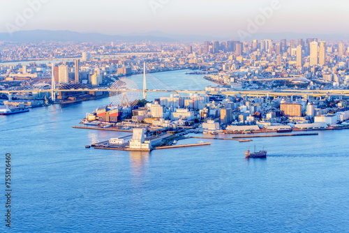 Sunset view of Osaka city at Osaka bay area with Industries locate around, cargo port and boat from Cosmo tower, selective focus.