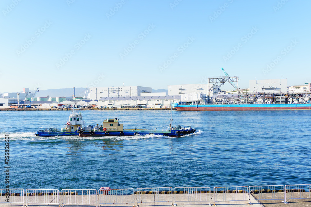 Sailing ship  through Osaka port , Marine cargo, large port city and commercial center on the Japanese island of Honshu, Osaka, Japan.