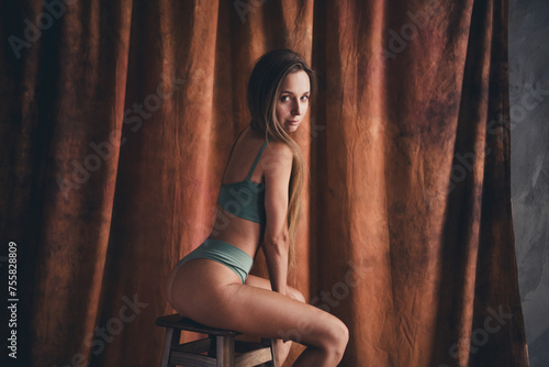 No retouch photo of gorgeous sporty young girl in underwear khaki lingerie posing sitting stool feminine isolated on brown color background © deagreez