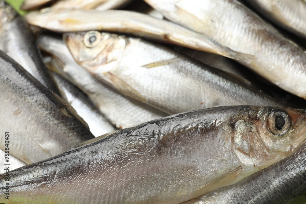 Fototapeta premium Fresh raw sprats as background, closeup view