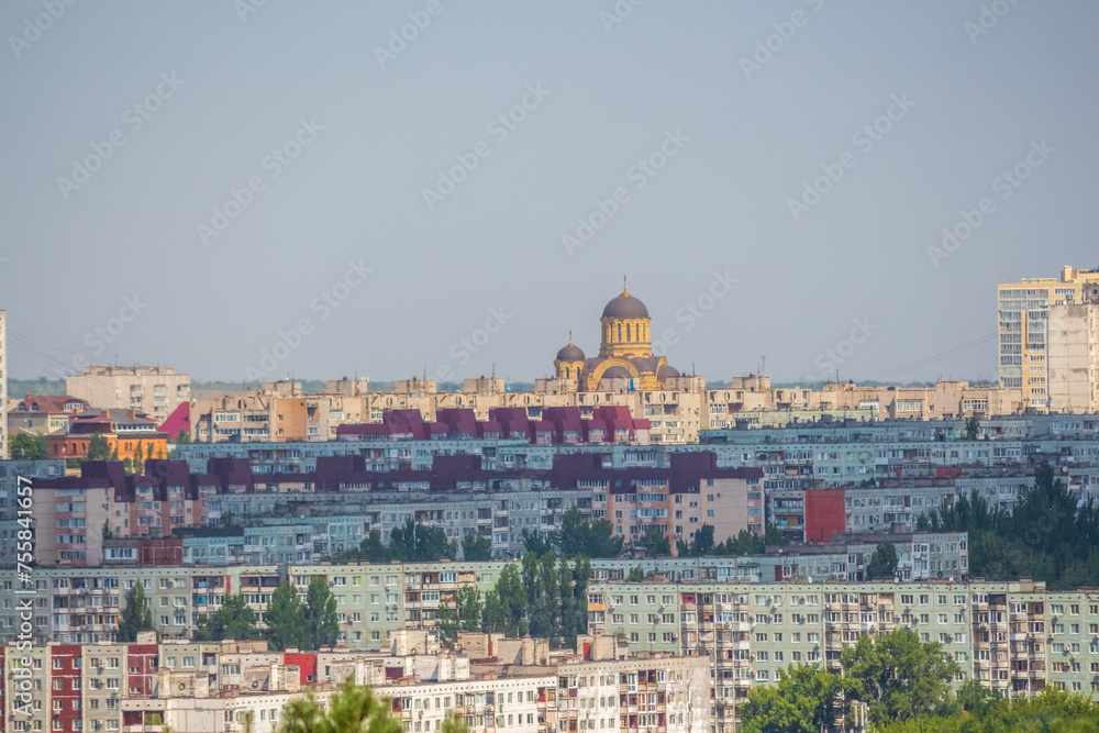 View from afar of Church of St. John of Kronstadt towering over residential district's buildings in Volgograd city, Russia in a sunny summer day. Copy space. Russian cityscape background.
