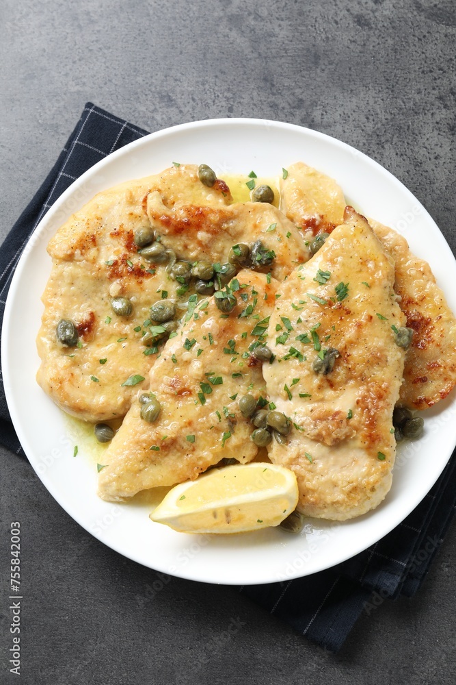 Delicious chicken piccata with herbs on grey table, top view Delicious chicken piccata with herbs on grey table, top view